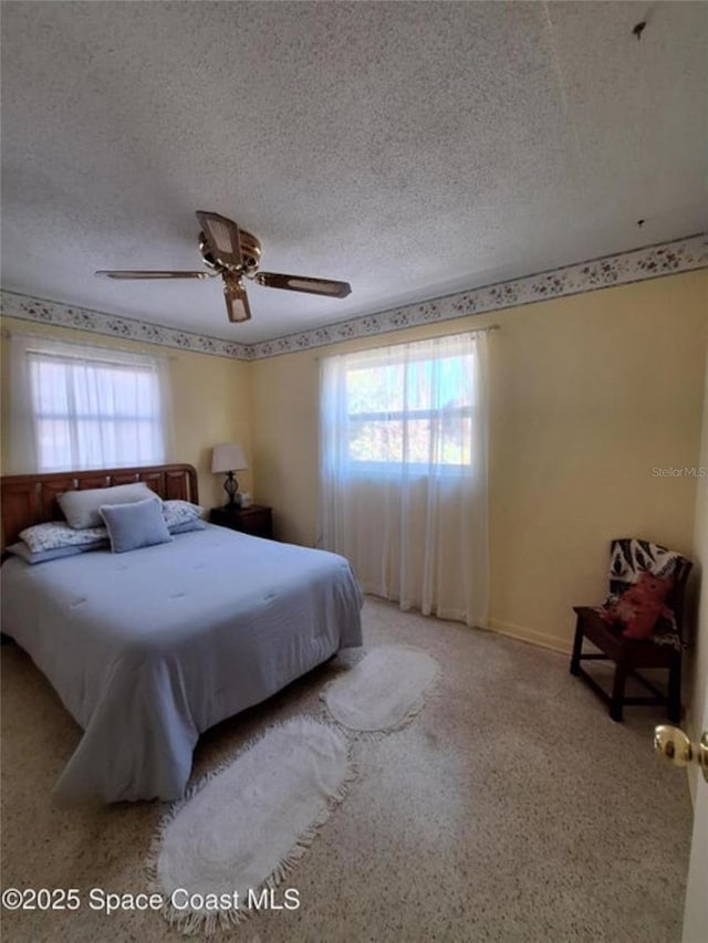 bedroom featuring ceiling fan and a textured ceiling