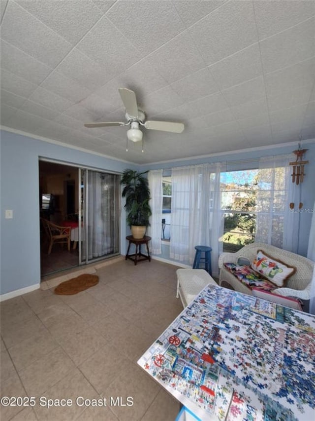 unfurnished bedroom featuring multiple windows, ornamental molding, and ceiling fan