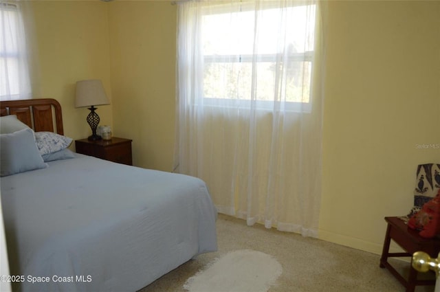 bedroom with light colored carpet