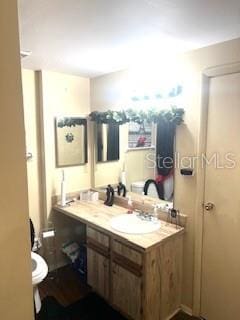 bathroom with vanity and toilet