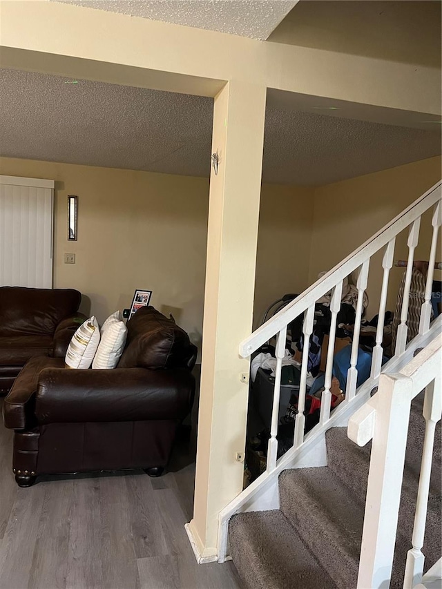 4944 Sanoma Vlg Unit D, Orlando, FL 32808 - stairway featuring a textured ceiling and wood finished floors