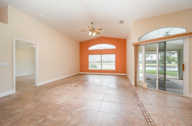 tiled empty room with lofted ceiling and ceiling fan