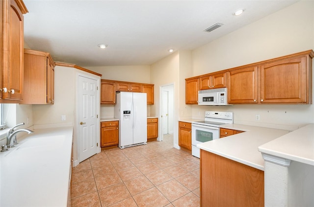 kitchen with white appliances, lofted ceiling, sink, and light tile patterned floors