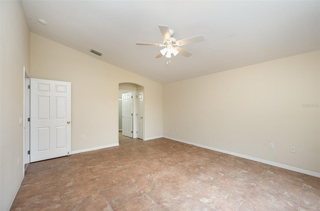 empty room featuring lofted ceiling and ceiling fan