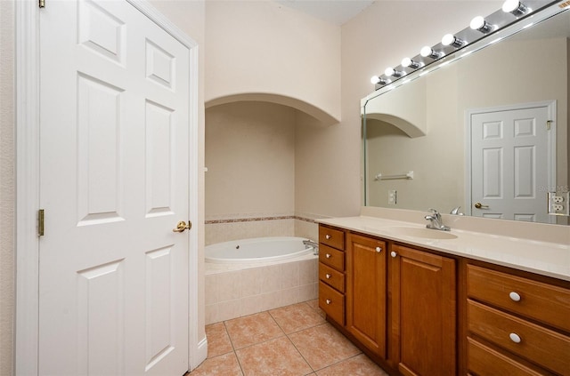 bathroom with vanity, tile patterned flooring, and tiled tub