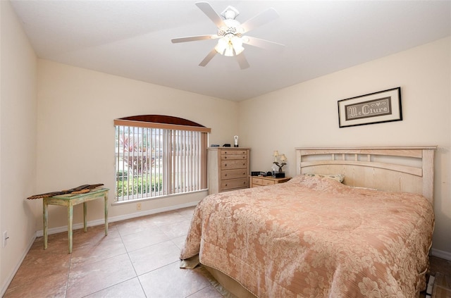 bedroom with ceiling fan and light tile patterned floors