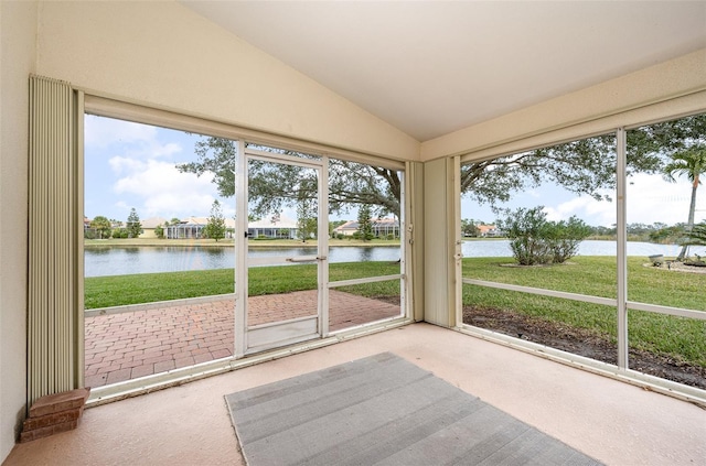 unfurnished sunroom with a water view and lofted ceiling