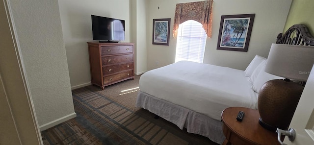 bedroom featuring dark carpet