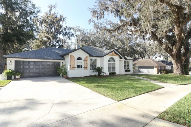 single story home with a garage and a front lawn