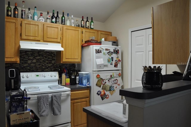 kitchen featuring decorative backsplash, white appliances, and lofted ceiling