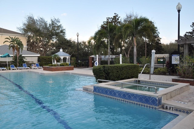 view of pool with a gazebo and a community hot tub