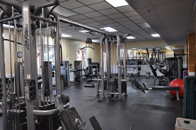 gym with a paneled ceiling