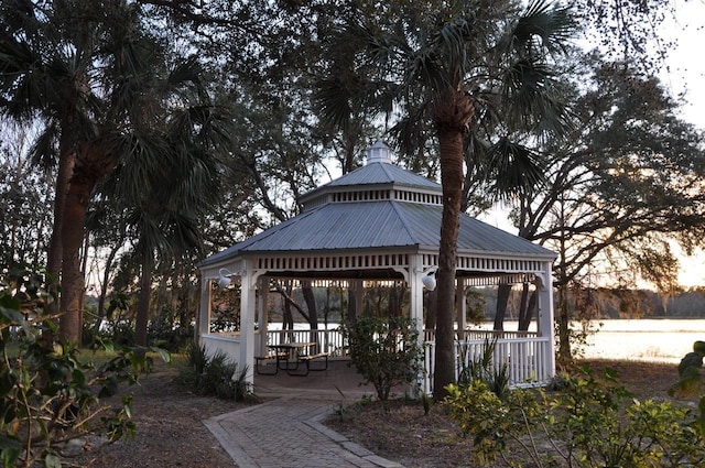 view of home's community with a water view and a gazebo