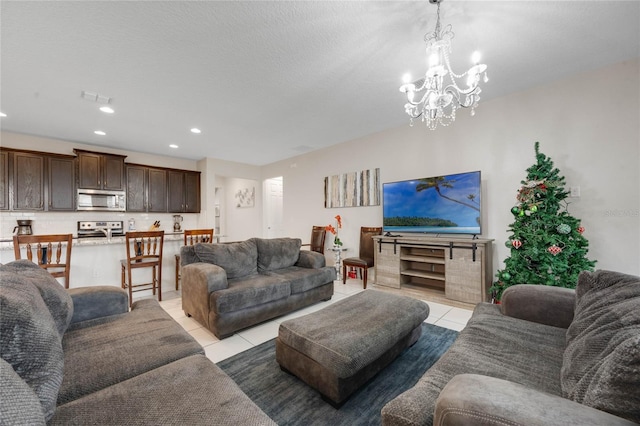 tiled living room featuring an inviting chandelier and a textured ceiling