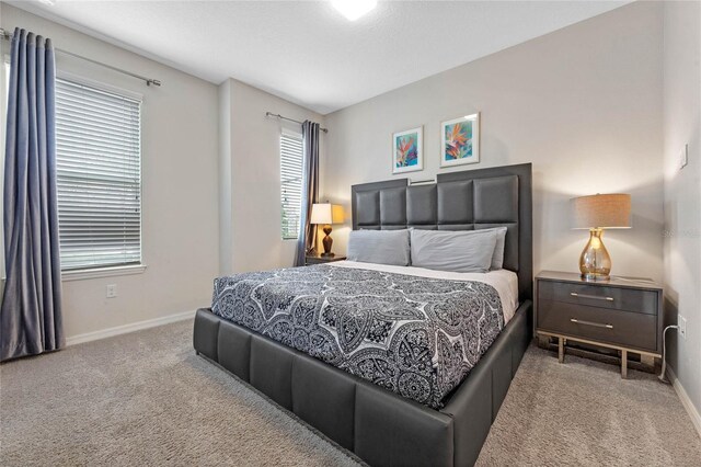 bedroom featuring light colored carpet