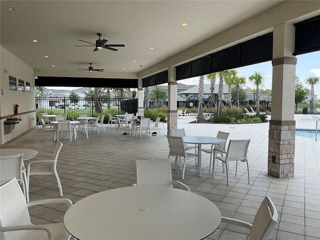 view of patio / terrace with fence, outdoor dining area, and a ceiling fan