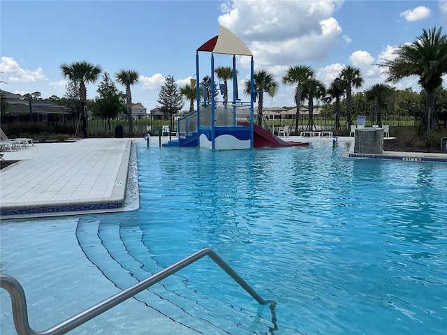 community pool with playground community and fence