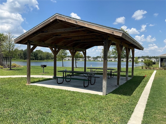 view of community featuring a gazebo, a patio, a lawn, and a water view