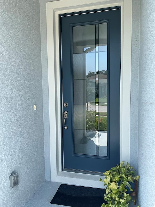 doorway to property with stucco siding