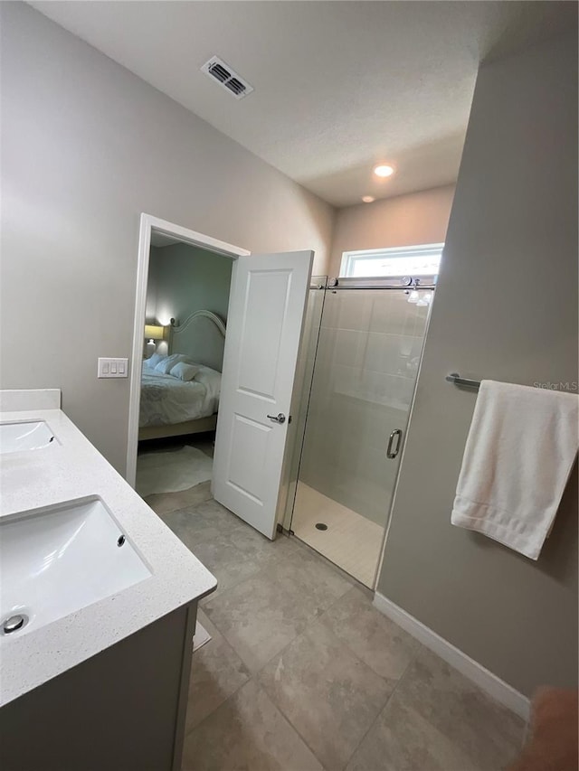 bathroom with ensuite bathroom, a sink, visible vents, a shower stall, and double vanity