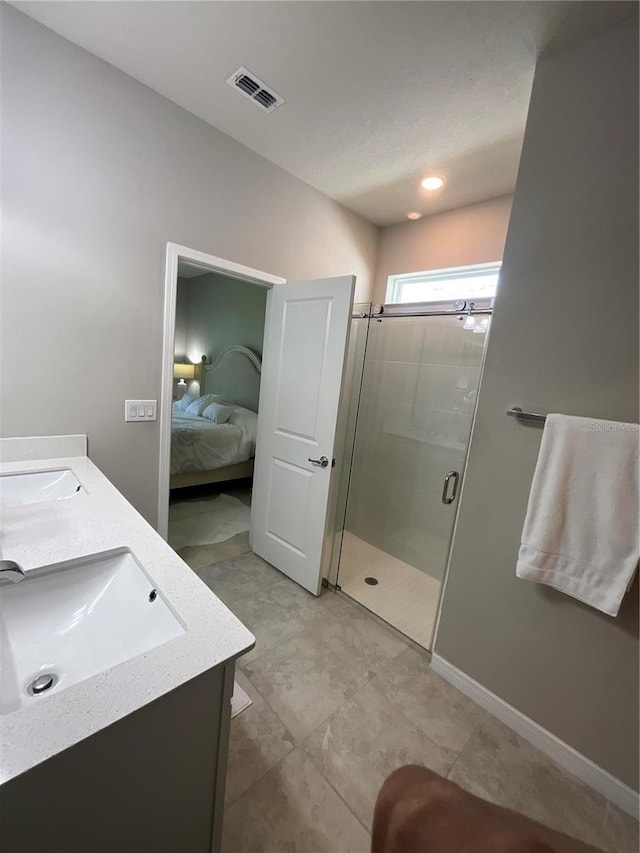 ensuite bathroom with a sink, visible vents, a shower stall, double vanity, and ensuite bath