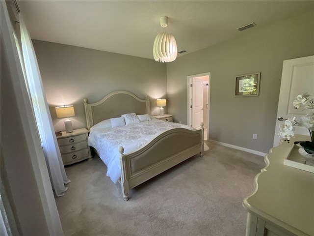 bedroom with baseboards, visible vents, and light colored carpet
