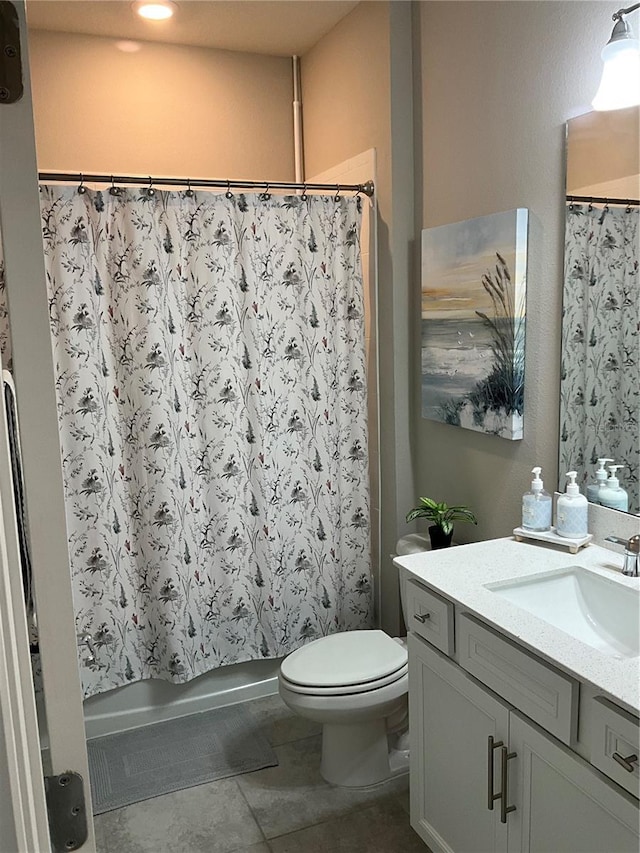bathroom with toilet, shower / bath combination with curtain, vanity, and tile patterned floors