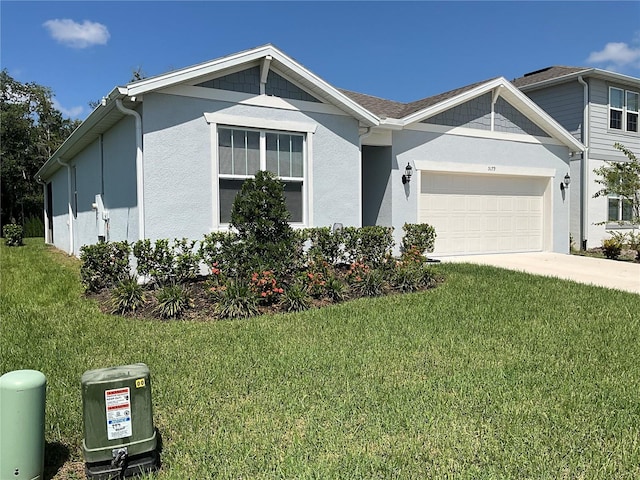 view of front facade featuring a garage, concrete driveway, a front yard, and stucco siding