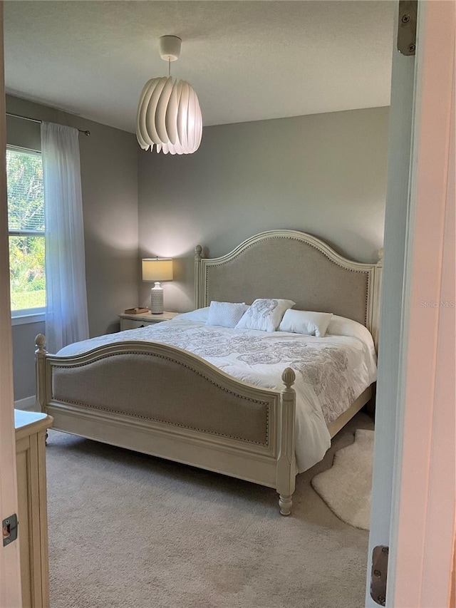 bedroom featuring light carpet