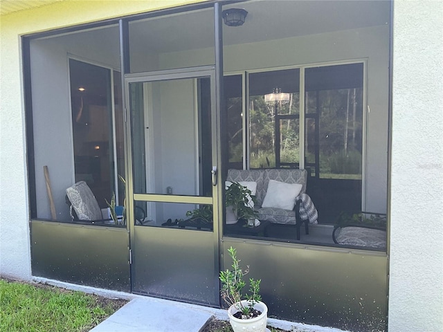entrance to property featuring stucco siding