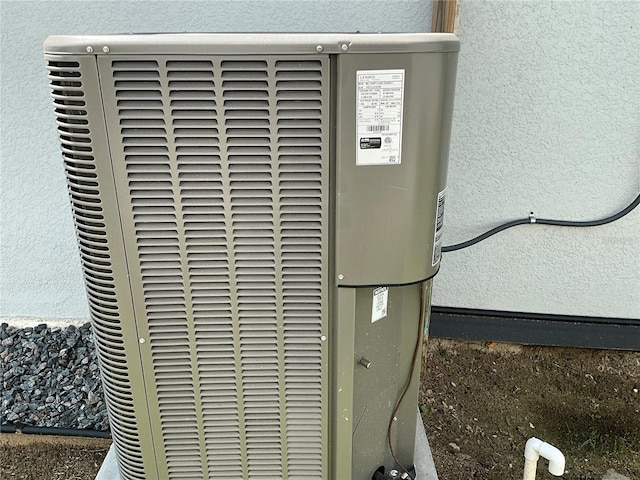 exterior details with central AC unit and stucco siding