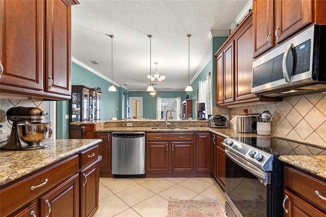 kitchen featuring decorative light fixtures, sink, decorative backsplash, light tile patterned floors, and stainless steel appliances