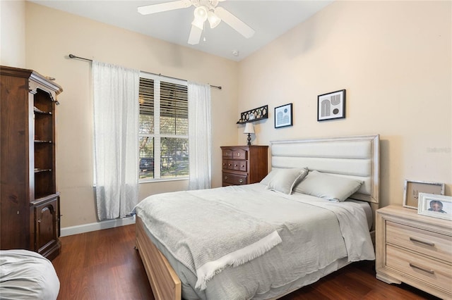 bedroom with dark hardwood / wood-style floors and ceiling fan