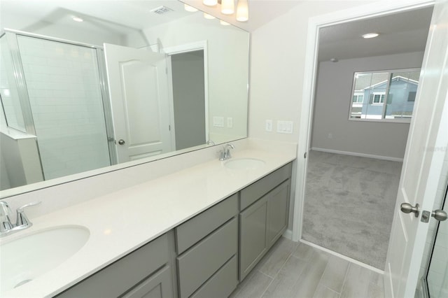 bathroom featuring vanity and a shower with shower door