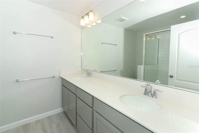 bathroom with an enclosed shower and vanity