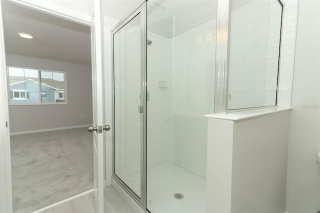 bathroom with a shower with door