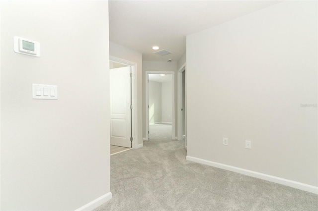 hall featuring light colored carpet