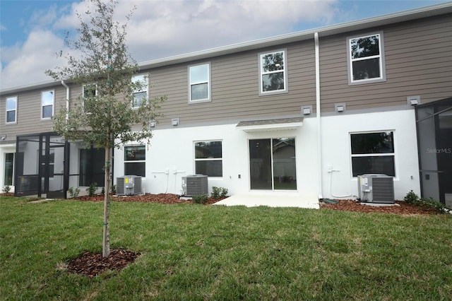 back of property featuring a yard and central AC unit