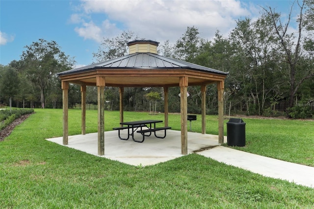 view of community with a gazebo, a lawn, and a patio area