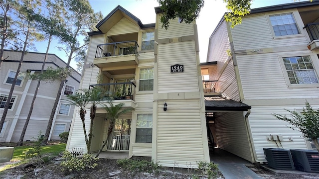 rear view of property with a balcony and central air condition unit