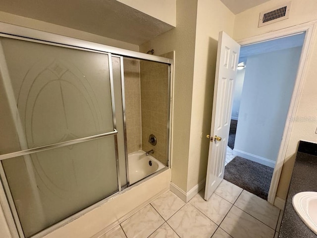 bathroom with vanity, tile patterned flooring, and shower / bath combination with glass door