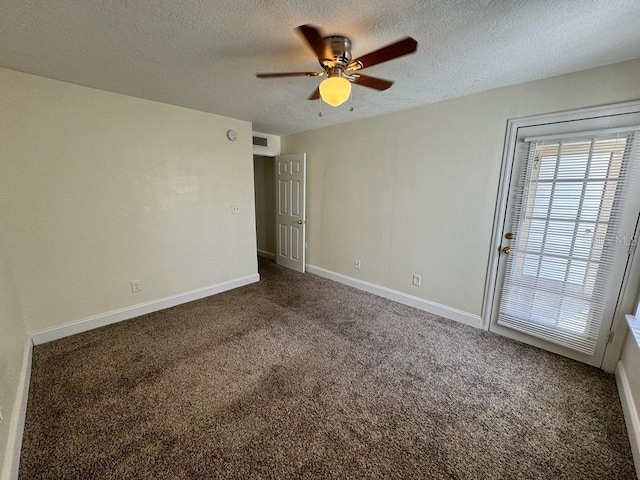 carpeted spare room featuring ceiling fan and a textured ceiling