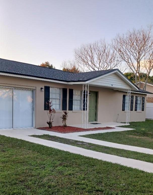 ranch-style home with a front lawn