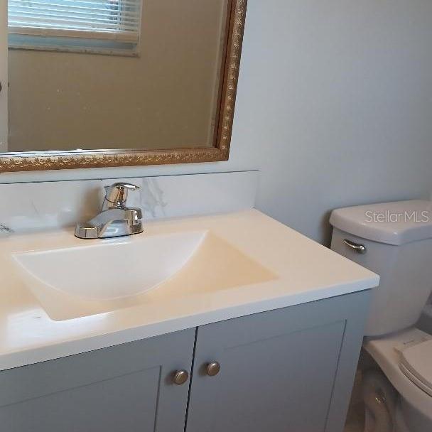 bathroom featuring vanity and toilet