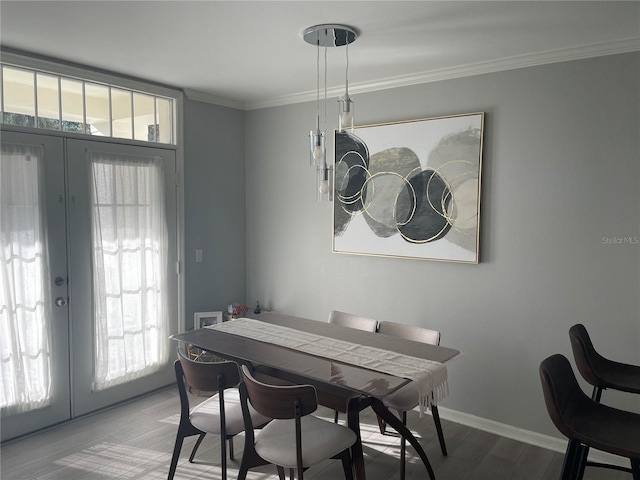 770 Siena Palm Dr Unit 201, Celebration, FL 34747 - dining room featuring crown molding, french doors, baseboards, and wood finished floors
