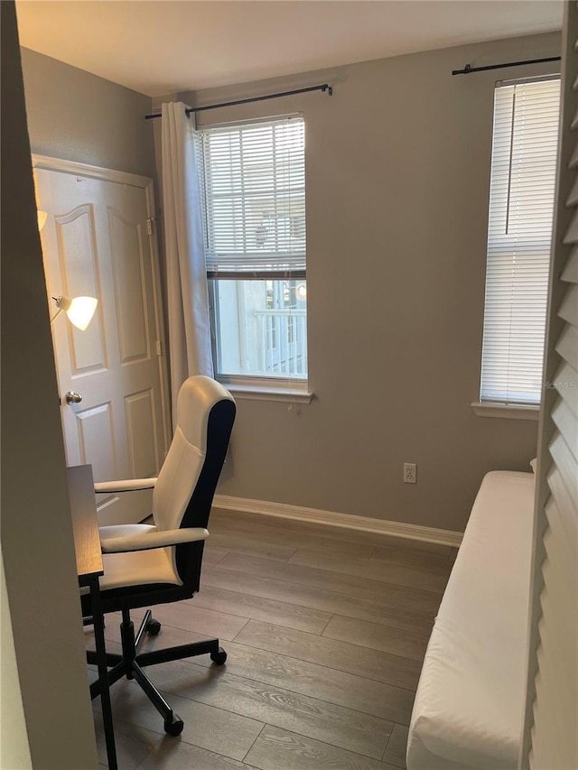 770 Siena Palm Dr Unit 201, Celebration, FL 34747 - office area featuring wood-type flooring, a wealth of natural light, and baseboards