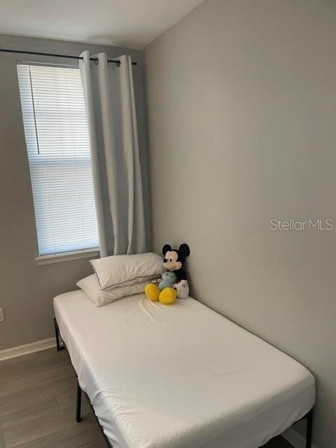 770 Siena Palm Dr Unit 201, Celebration, FL 34747 - bedroom featuring wood finished floors and baseboards
