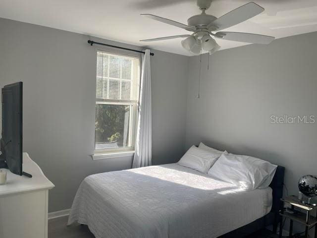 770 Siena Palm Dr Unit 201, Celebration, FL 34747 - bedroom with baseboards and a ceiling fan