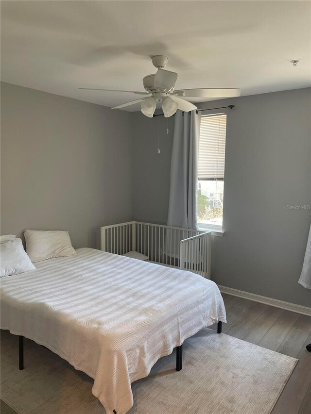 770 Siena Palm Dr Unit 201, Celebration, FL 34747 - bedroom featuring baseboards, a ceiling fan, and wood finished floors