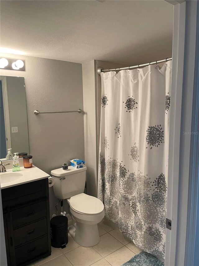770 Siena Palm Dr Unit 201, Celebration, FL 34747 - bathroom featuring tile patterned flooring, curtained shower, vanity, and toilet
